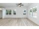 Bright living room featuring three windows and light wood-look flooring at 1047 |1049 E Harnett St, Dunn, NC 28334