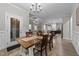 Inviting dining room with a rustic table, open to kitchen and living spaces at 105 Jasper Creek Ct, Wilson's Mills, NC 27520