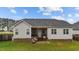 Charming backyard with screened porch, patio, and lush green lawn at 105 Jasper Creek Ct, Wilson's Mills, NC 27520