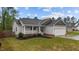 Well-maintained home with a two-car garage, inviting front porch, and landscaped garden at 105 Jasper Creek Ct, Wilson's Mills, NC 27520