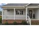 Charming front porch with hanging plants, a welcoming wreath, and a cozy, inviting atmosphere at 105 Jasper Creek Ct, Wilson's Mills, NC 27520