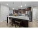 Spacious kitchen features a large island with seating, modern appliances, and ample cabinet space at 105 Jasper Creek Ct, Wilson's Mills, NC 27520