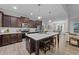 Modern kitchen features a large center island, stainless steel appliances, and elegant cabinetry at 105 Jasper Creek Ct, Wilson's Mills, NC 27520