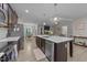 Bright kitchen boasts stainless appliances, a large island, and an open view to the dining and living areas at 105 Jasper Creek Ct, Wilson's Mills, NC 27520
