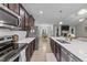 Modern kitchen boasting dark wood cabinets, white countertops, and stainless steel appliances at 105 Jasper Creek Ct, Wilson's Mills, NC 27520