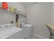 Functional laundry room with washer, dryer, and storage shelving at 105 Jasper Creek Ct, Wilson's Mills, NC 27520