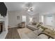 Bright living room featuring a vaulted ceiling, fireplace, and comfortable seating at 105 Jasper Creek Ct, Wilson's Mills, NC 27520