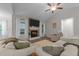 Cozy living room featuring a stone fireplace, large windows, and comfortable seating at 105 Jasper Creek Ct, Wilson's Mills, NC 27520