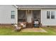 Outdoor patio with grill, chairs, and convenient access to the screened porch at 105 Jasper Creek Ct, Wilson's Mills, NC 27520
