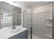 Bathroom featuring a shower, vanity with mirror and plenty of light at 1057 |1059 E Harnett St, Dunn, NC 28334