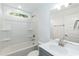 Well-lit bathroom with a vanity sink, mirror and shower-tub combination at 1057 |1059 E Harnett St, Dunn, NC 28334