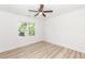 Bright bedroom featuring wood-look floors, a ceiling fan and a window offering outdoor views at 1057 |1059 E Harnett St, Dunn, NC 28334