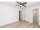 A bright bedroom has wood-look floors, closet and adjoins a bathroom with a glass enclosed shower at 1057 |1059 E Harnett St, Dunn, NC 28334