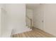 Bright entryway with light wood floors, stairs, built-in storage, and white interior door at 1057 |1059 E Harnett St, Dunn, NC 28334