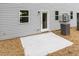 Exterior patio area with backyard access to the home with white patio and well kept lawn at 1057 |1059 E Harnett St, Dunn, NC 28334