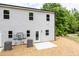 Back exterior of a two story home with light gray siding and windows with back patios at 1057 |1059 E Harnett St, Dunn, NC 28334