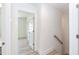 Hallway with staircase and view into another room, featuring clean lines and wood grain tile flooring at 1057 |1059 E Harnett St, Dunn, NC 28334