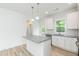 Eat-in kitchen featuring white cabinets, granite countertops and stainless appliances, plus an island at 1057 |1059 E Harnett St, Dunn, NC 28334