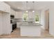 Bright kitchen features granite counters, stainless appliances, and an island with pendant lighting at 1057 |1059 E Harnett St, Dunn, NC 28334