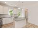 Bright kitchen features granite counters, stainless appliances, and an island with pendant lighting at 1057 |1059 E Harnett St, Dunn, NC 28334