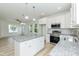 Kitchen featuring white cabinetry, granite countertops, stainless steel appliances and central island at 1057 |1059 E Harnett St, Dunn, NC 28334