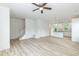 Open-concept living space with staircase and a view of the kitchen with pendant lighting at 1057 |1059 E Harnett St, Dunn, NC 28334