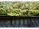 View from the rustic deck overlooking a private wooded area at 108 W Savannah Ridge Rd, Holly Springs, NC 27540
