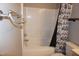 Clean bathroom with a tub and white tile and black and white floral shower curtain at 108 W Savannah Ridge Rd, Holly Springs, NC 27540