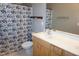 Bathroom featuring double vanity with wood cabinets and a black and white floral shower curtain at 108 W Savannah Ridge Rd, Holly Springs, NC 27540