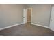 Spacious bedroom with neutral carpet, trim, and paint, featuring an ensuite bath at 108 W Savannah Ridge Rd, Holly Springs, NC 27540