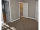 Neutral bedroom featuring plush carpeting, closet, and access to an ensuite bathroom at 108 W Savannah Ridge Rd, Holly Springs, NC 27540