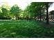 Expansive green space with mature trees offers a serene and park-like setting at 108 W Savannah Ridge Rd, Holly Springs, NC 27540