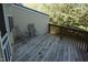 Wooden deck with chairs and a small table, perfect for outdoor relaxation and enjoying nature views at 108 W Savannah Ridge Rd, Holly Springs, NC 27540