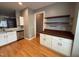 Dining room with cabinet and counter, wood floors, with open access to the kitchen at 108 W Savannah Ridge Rd, Holly Springs, NC 27540