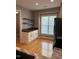 Open dining room with wood floors, built-in counter and shelves and window with blinds at 108 W Savannah Ridge Rd, Holly Springs, NC 27540
