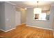 Bright dining area connected to kitchen with hardwood floors and updated fixtures at 108 W Savannah Ridge Rd, Holly Springs, NC 27540
