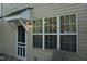 Exterior showing the entry door, large picture window, and chair on the deck at 108 W Savannah Ridge Rd, Holly Springs, NC 27540