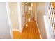 Bright hallway with gleaming hardwood floors and neutral paint, connecting rooms at 108 W Savannah Ridge Rd, Holly Springs, NC 27540