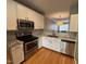 Bright, remodeled kitchen featuring stainless steel appliances, updated counters, and subway tile at 108 W Savannah Ridge Rd, Holly Springs, NC 27540