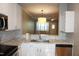 Well-appointed kitchen with modern sink, white cabinetry, and view into the living area at 108 W Savannah Ridge Rd, Holly Springs, NC 27540