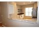 Open kitchen with stone countertops, stainless steel appliances, and built-in storage at 108 W Savannah Ridge Rd, Holly Springs, NC 27540