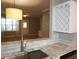 Gourmet kitchen boasts stone countertops, stainless steel appliances, and natural light at 108 W Savannah Ridge Rd, Holly Springs, NC 27540