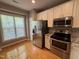 Kitchen with hardwood floors, stainless steel appliances, subway tile, and white cabinets at 108 W Savannah Ridge Rd, Holly Springs, NC 27540