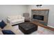 Cozy living room featuring comfortable seating, accent pillows, and a fireplace for relaxation at 108 W Savannah Ridge Rd, Holly Springs, NC 27540