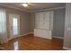 The living room offers natural light and a built in entertainment center with cabinets and shelving for storage and display at 108 W Savannah Ridge Rd, Holly Springs, NC 27540