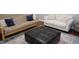 Inviting living room showcasing a modern ottoman and cozy seating arrangement at 108 W Savannah Ridge Rd, Holly Springs, NC 27540