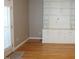 Living room featuring custom built-in shelving, hardwood floors, and natural light at 108 W Savannah Ridge Rd, Holly Springs, NC 27540
