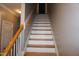 Bright staircase with wooden handrail leading to the upper level at 108 W Savannah Ridge Rd, Holly Springs, NC 27540