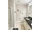 Bathroom boasts a black granite counter, white cabinets, and a glass enclosed shower at 1129 Kudzu St, Durham, NC 27713