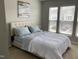Bright bedroom featuring a plush bed, neutral walls, and a sunlit window at 1129 Kudzu St, Durham, NC 27713